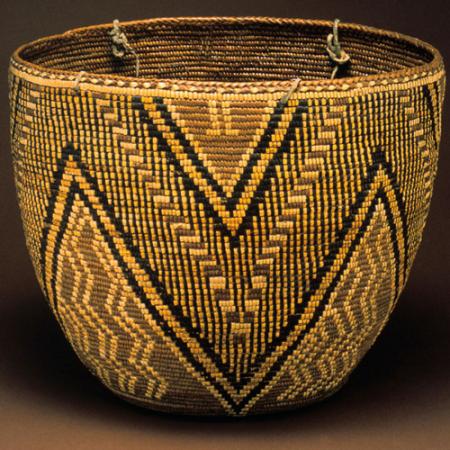 A completed woven basket with black diamond patters