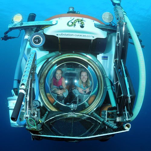 two women inside a submersible porthole window